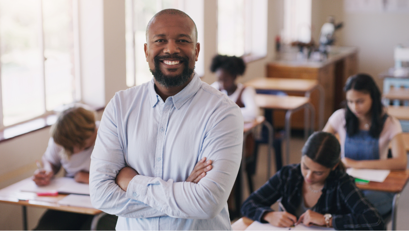 diverse teacher in front of classroom